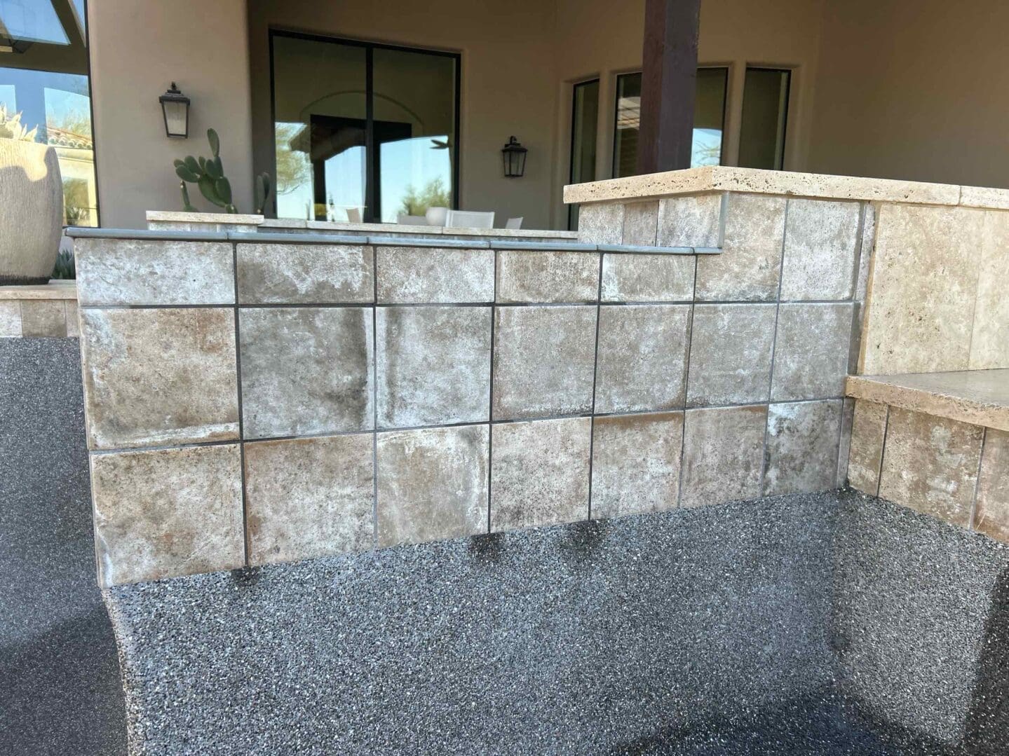Stone wall with square tiles outdoors.